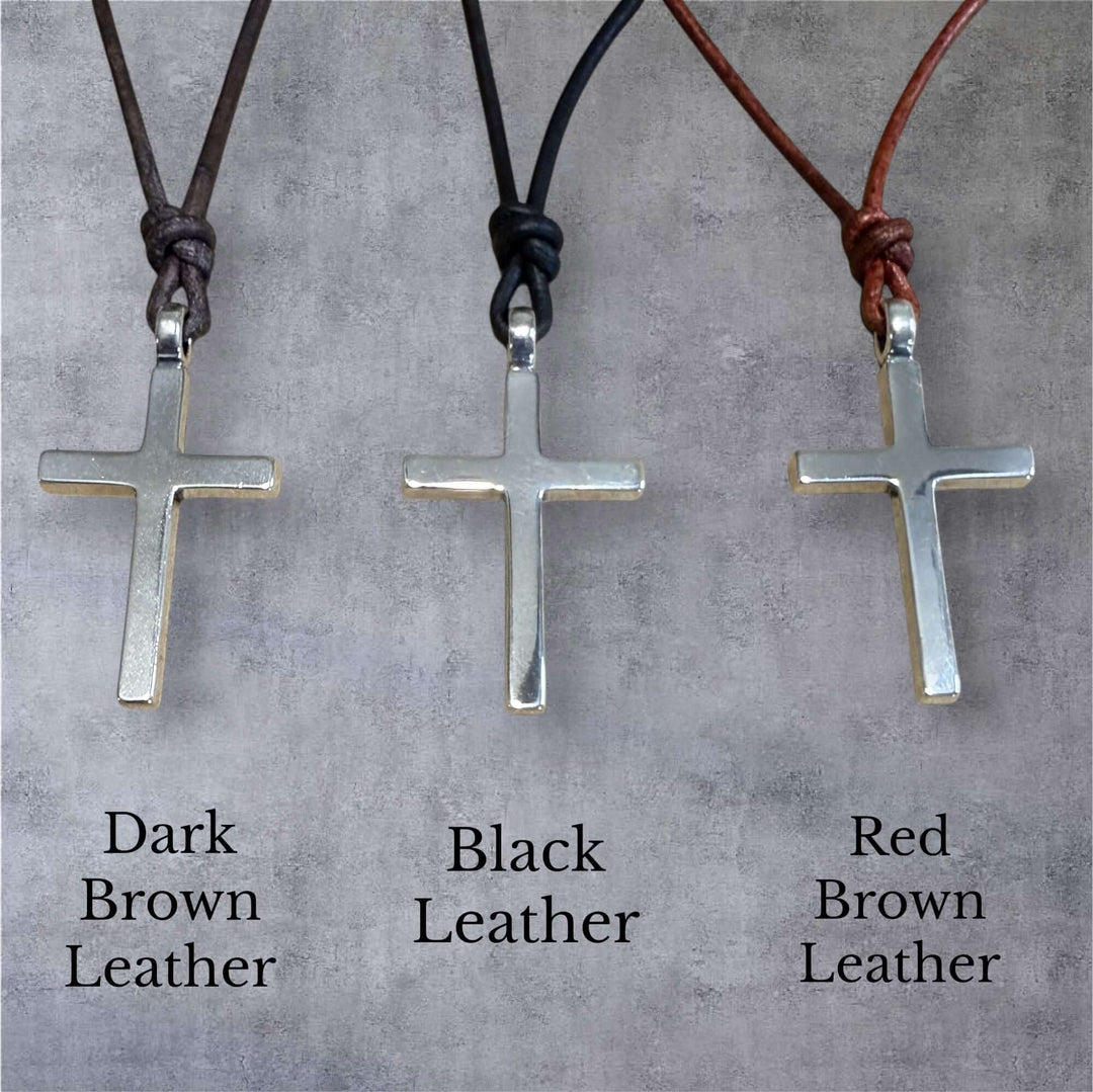 Handcrafted solid sterling silver cross on an adjustable leather cord. Unisex. Available in black, dark brown, or red brown. Made in USA
