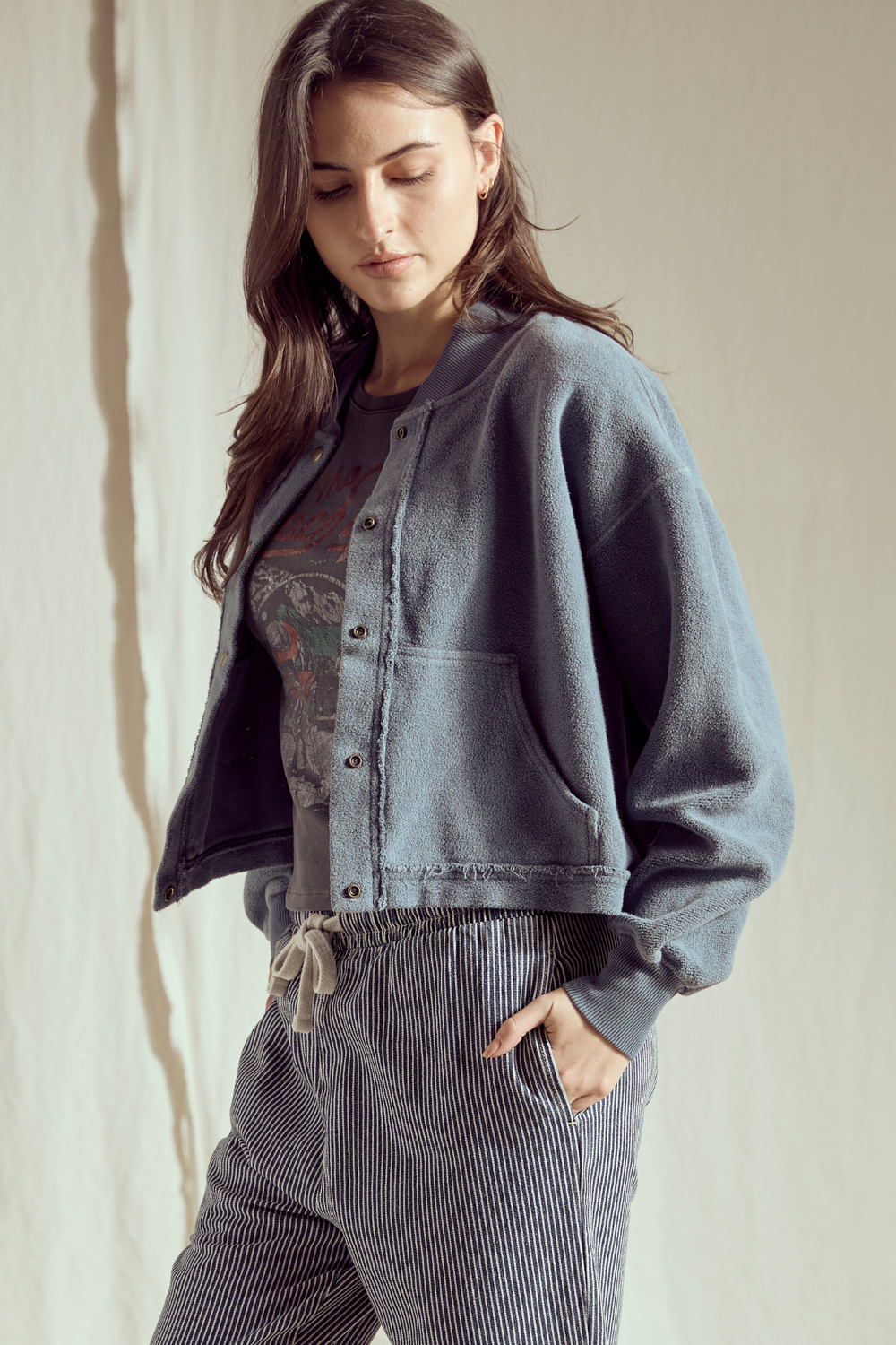 Shop the Sundown Jacket by People of Leisure — an oversized 100% organic fleece jacket with pockets, bold buttons & drawstring waist. In Vintage Black & Navy. Sizes XS–XL.