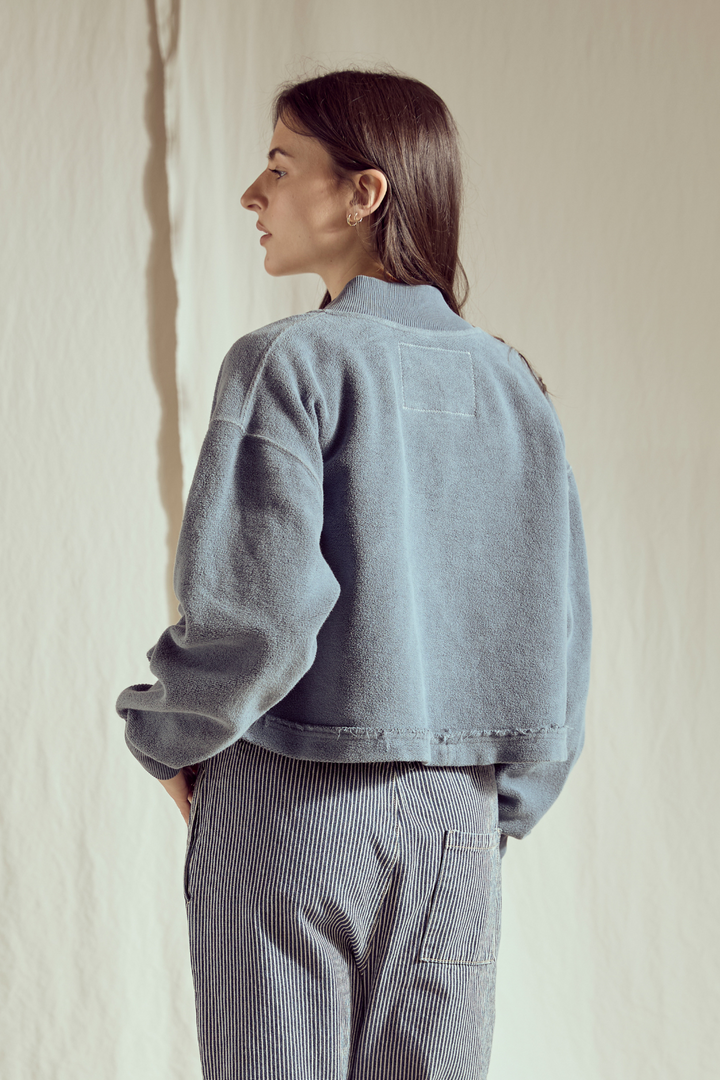 Shop the Sundown Jacket by People of Leisure — an oversized 100% organic fleece jacket with pockets, bold buttons &amp; drawstring waist. In Vintage Black &amp; Navy. Sizes XS–XL.