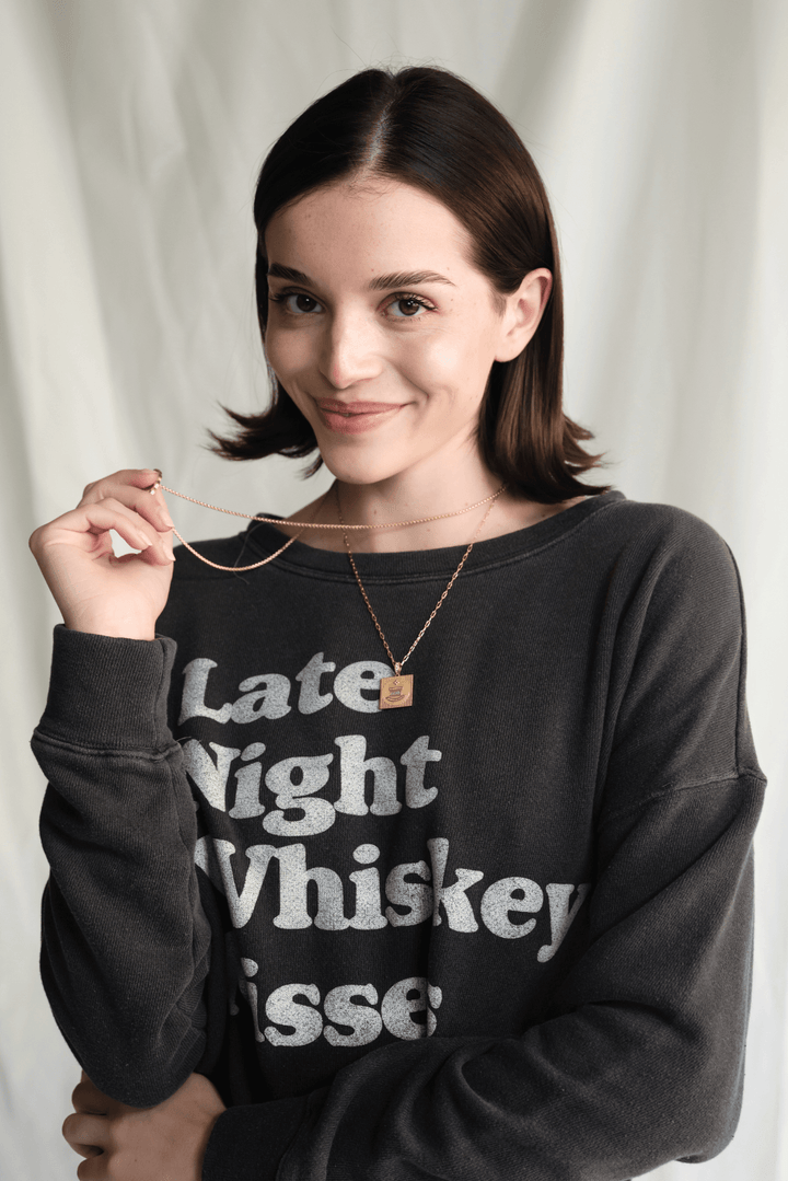 Whiskey Kisses Sweatshirt by People of Leisure — vintage-inspired graphic crewneck in Vintage Black. Ethically made in LA. Sizes XS–XL.