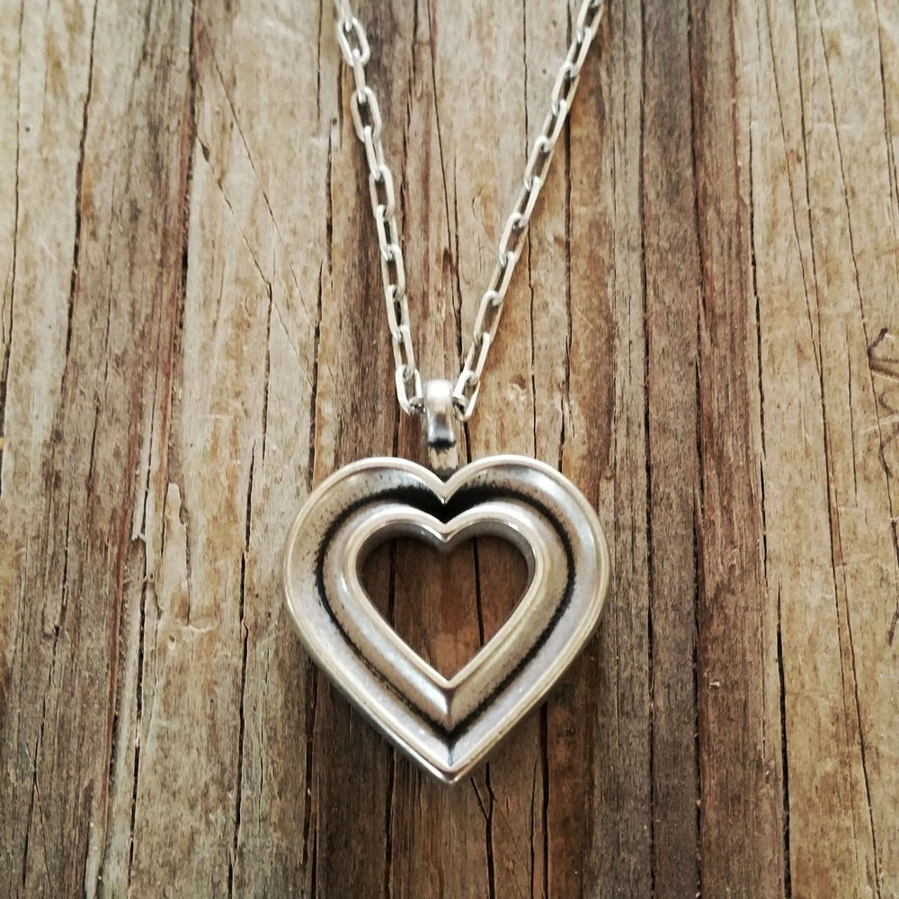 Handcrafted solid sterling silver heart necklace on an 18-24 inch stainless steel chain. Made in USA with a lifetime warranty.