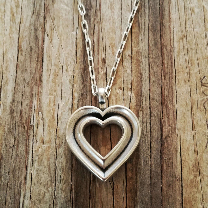 Handcrafted solid sterling silver heart necklace on an 18-24 inch stainless steel chain. Made in USA with a lifetime warranty.