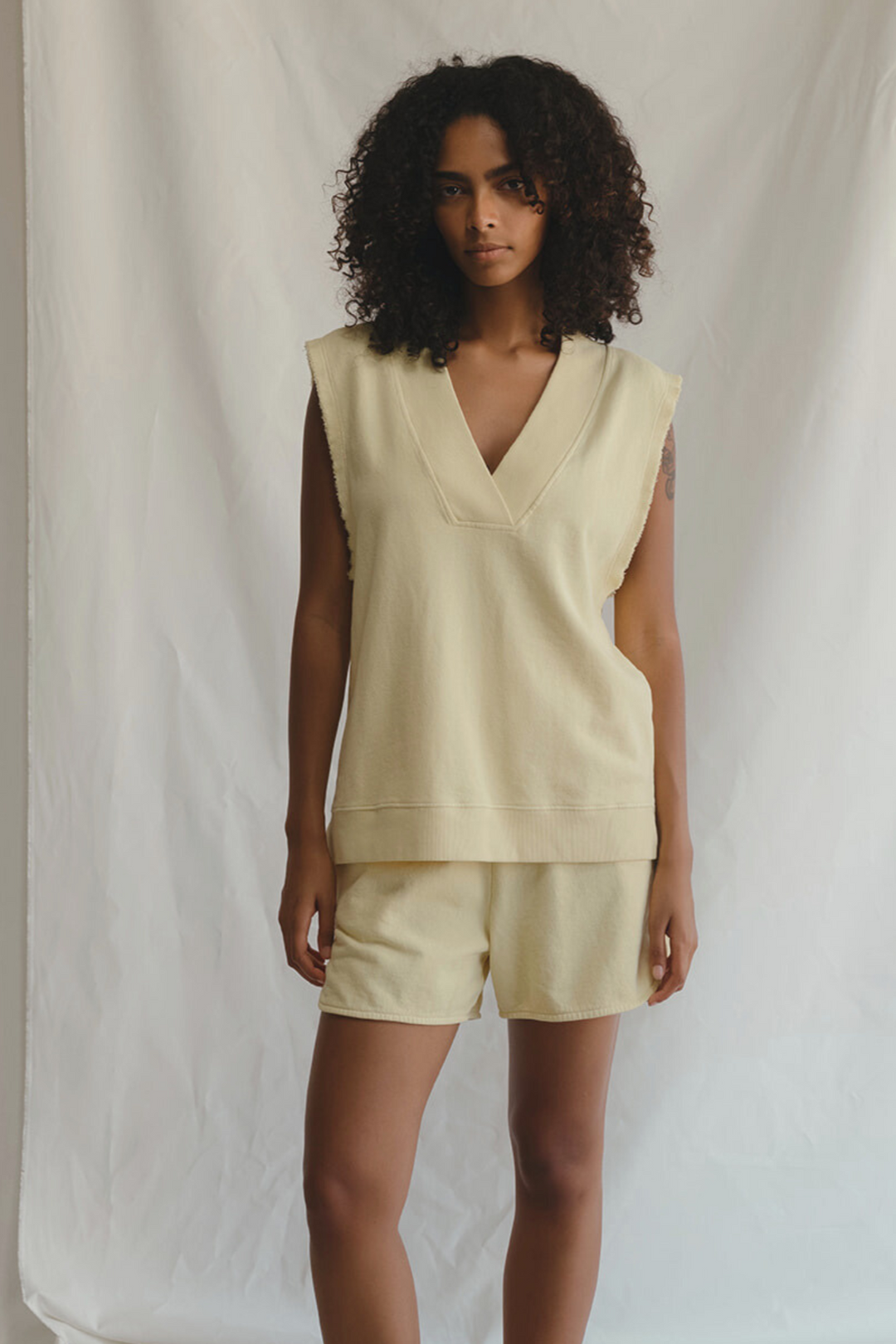 Shop the Villa Vest by People of Leisure — raw edge, ribbed V-neck in hemp &amp; organic cotton. Limoncello &amp; Sand. Sizes XS–XL.