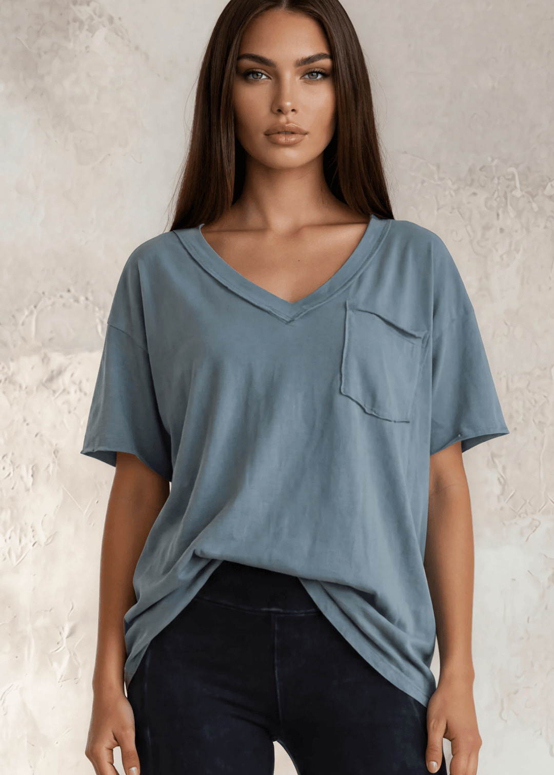 This Made in USA Slate Blue T-Shirt offers a relaxed fit made from soft, 100% cotton medium-weight fabric that is garment washed for lasting comfort. Featuring a raw edge detail and a convenient front pocket, this short-sleeve tee is perfect for everyday wear.