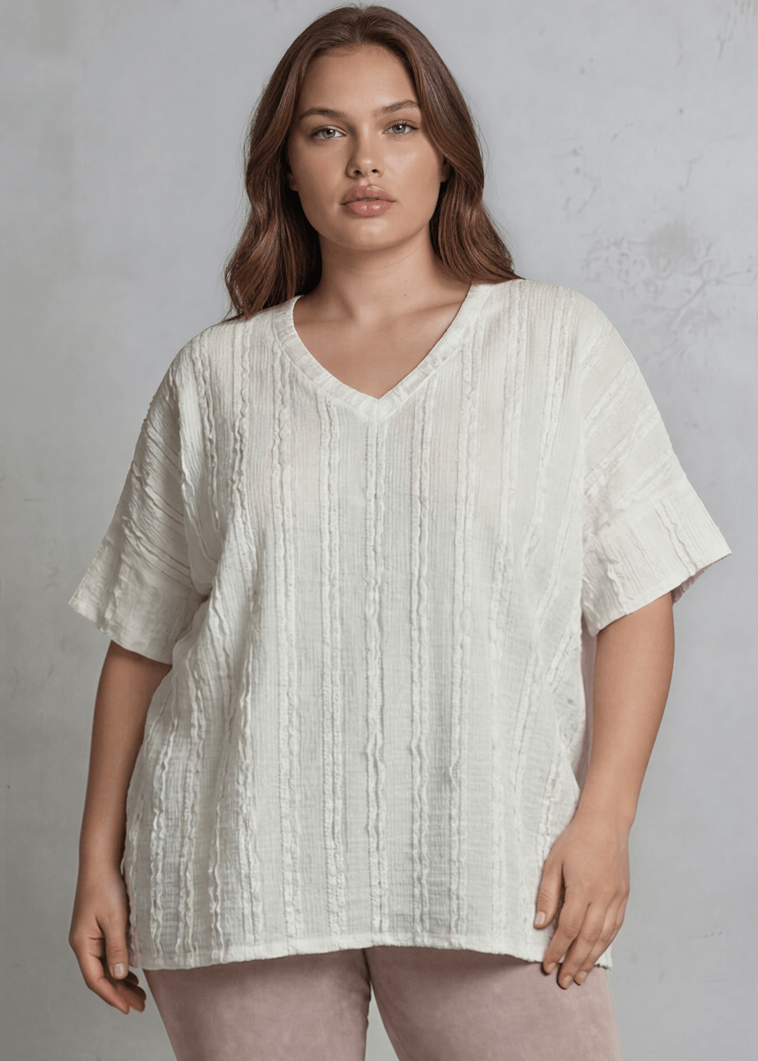 Shop the Plus Size Laurel Textured Top — relaxed oversized v-neck with striped lace effect, contrast sleeve bands & side slit. Sizes 1X–3X. Made in USA.