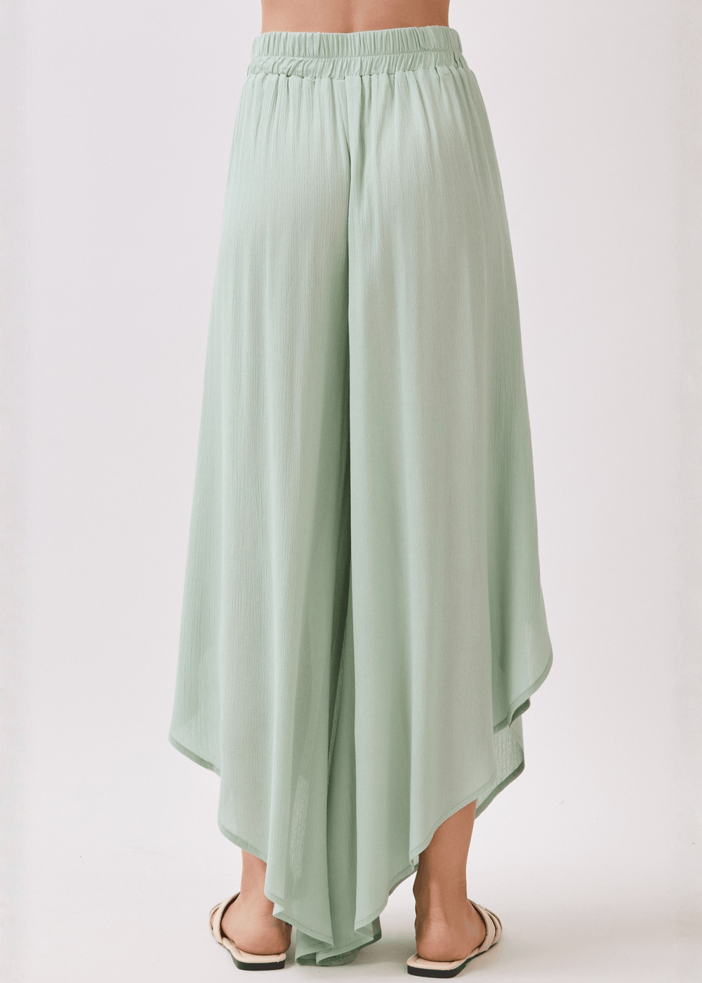 Breezy sage green flowy pants with elastic waist & overlap split leg detail. Lightweight 100% rayon. Made in USA. Perfect for vacation & resort wear.