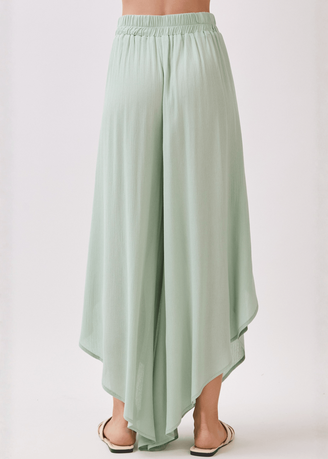 Breezy sage green flowy pants with elastic waist &amp; overlap split leg detail. Lightweight 100% rayon. Made in USA. Perfect for vacation &amp; resort wear.