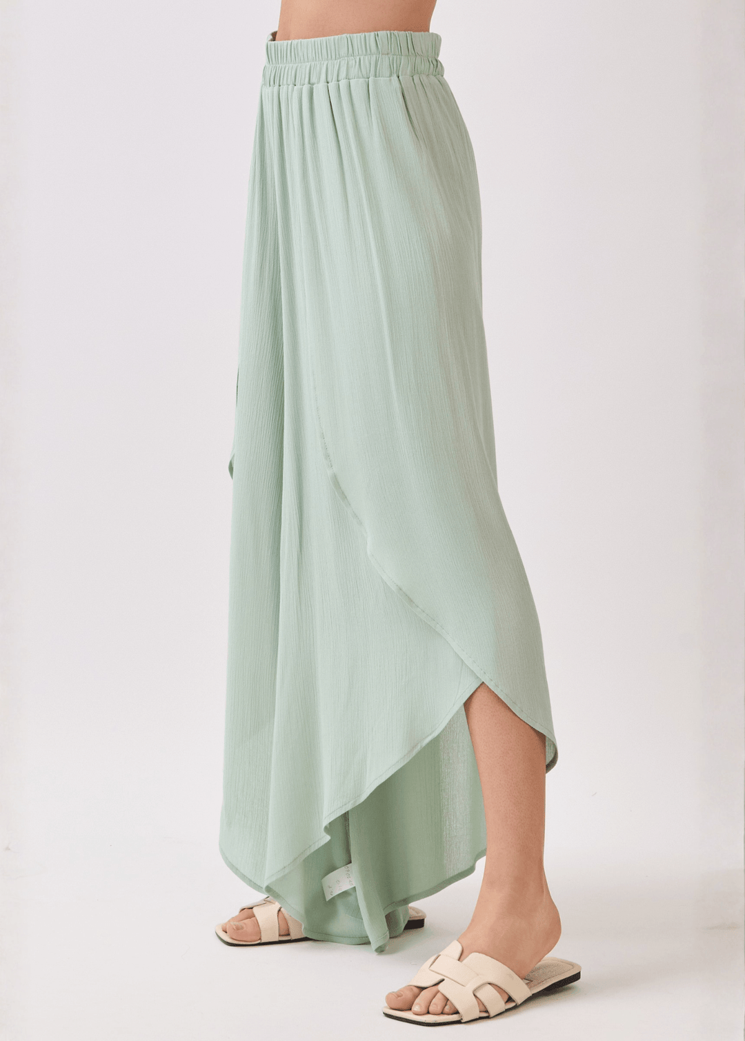 Breezy sage green flowy pants with elastic waist &amp; overlap split leg detail. Lightweight 100% rayon. Made in USA. Perfect for vacation &amp; resort wear.