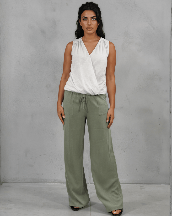 Shop the Courtney Cotton Surplice V Neck Top in White. Relaxed blousy fit, feminine V-neckline, soft 95% cotton. Proudly made in the USA. Sizes S–L.  Renee C Style 3463TP Paired with  Annie wide leg pants in light olive — adjustable drawstring waist, side pockets, rayon-linen blend. Relaxed fit, Made in USA. Perfect for resort &amp; vacation wear.