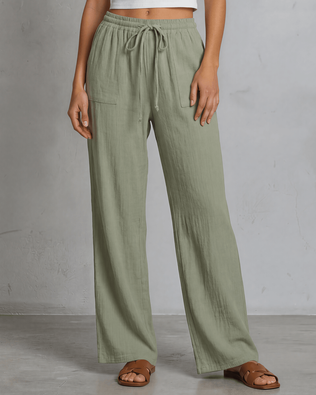 Annie wide leg pants in light olive — adjustable drawstring waist, side pockets, rayon-linen blend. Relaxed fit, Made in USA. Perfect for resort & vacation wear.