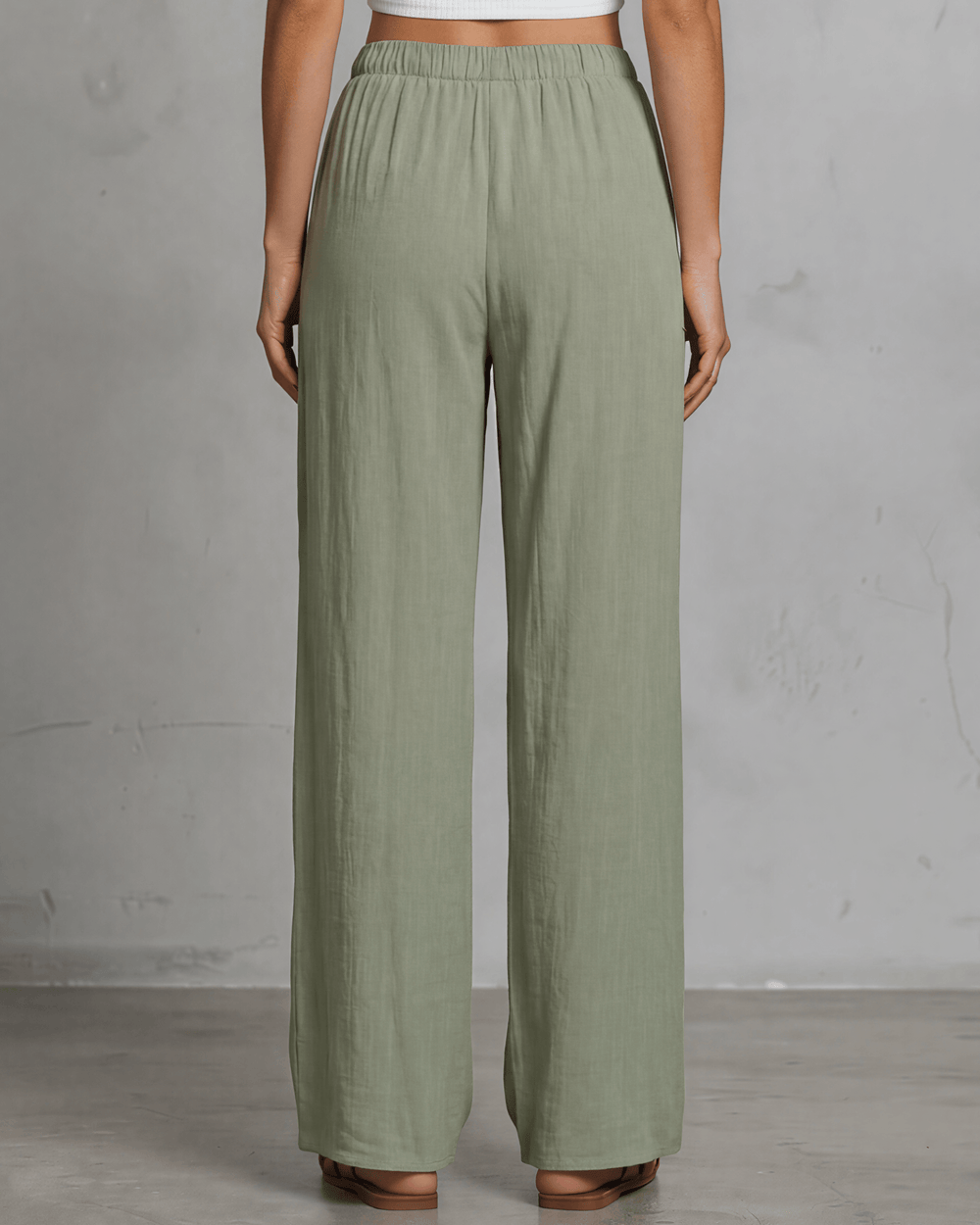 Annie wide leg pants in light olive — adjustable drawstring waist, side pockets, rayon-linen blend. Relaxed fit, Made in USA. Perfect for resort & vacation wear.