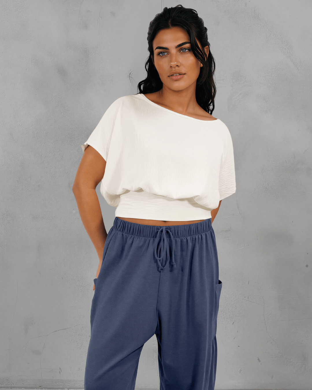 Shop the Sandra Flowy Short Sleeve Top with Smocked Waist in White. Blousy crop top, fitted smocked waist, 100% polyester. Made in USA. Sizes S–L.