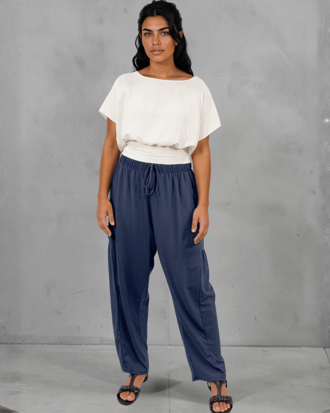 Shop the Sandra Flowy Short Sleeve Top with Smocked Waist in White. Blousy crop top, fitted smocked waist, 100% polyester. Made in USA. Sizes S–L.