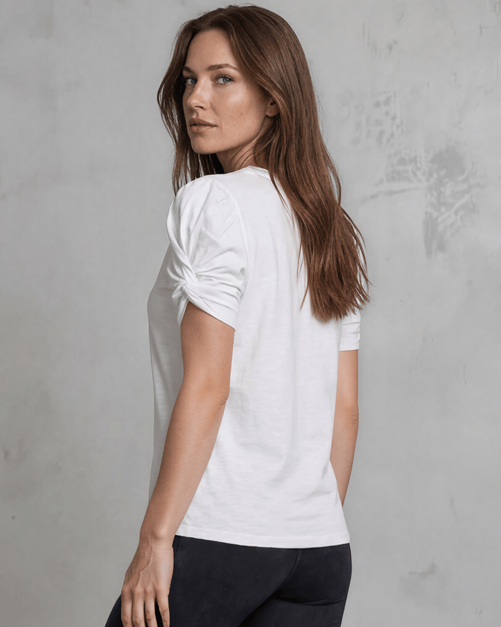 Milly Cotton Puff Sleeve Top with ruched knot detail. Soft cotton-spandex, crew neck, relaxed fit. Elevated everyday style. Made in USA.