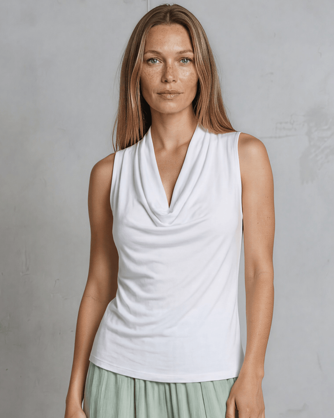 Nikki Cowl Neck Jersey Top in White. Soft rayon-spandex, draped cowl neck, semi-fitted, sleeveless. Polished & versatile. Made in USA. Sizes S–L.