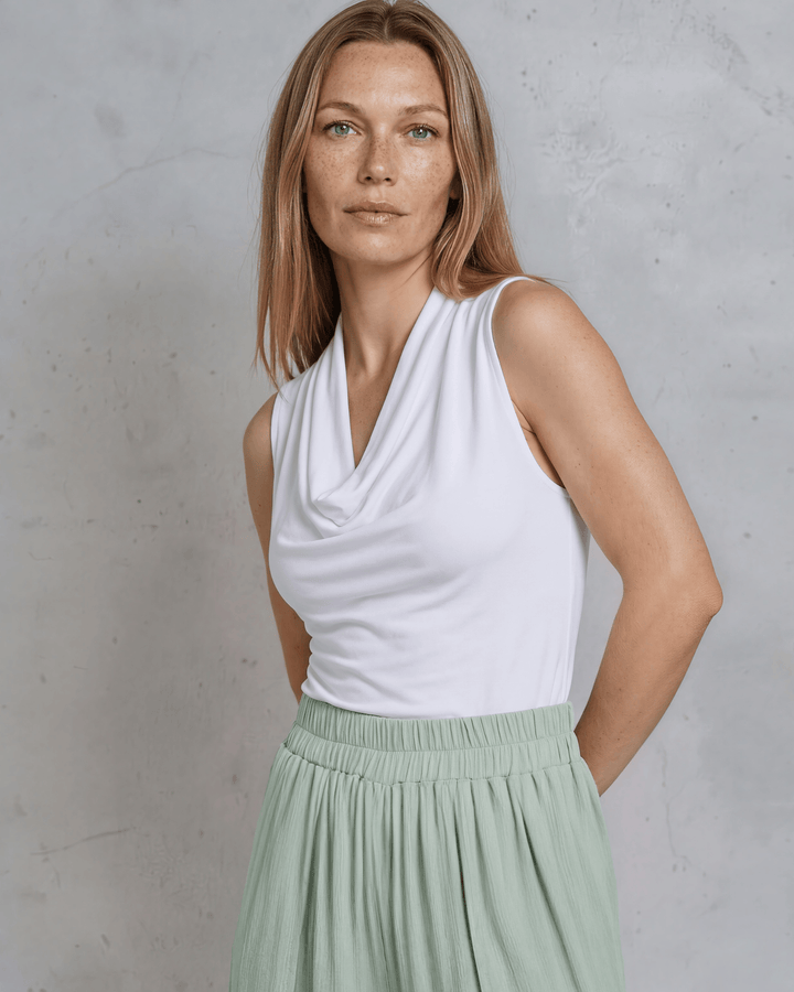 Nikki Cowl Neck Jersey Top in White. Soft rayon-spandex, draped cowl neck, semi-fitted, sleeveless. Polished &amp; versatile. Made in USA. Sizes S–L.