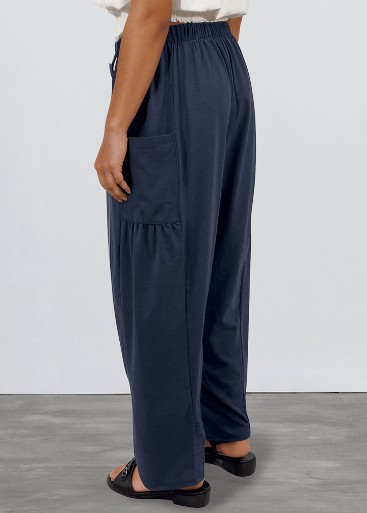 Shop the Bailey Baggy Drawstring Pants in Navy. Relaxed fit, deep pockets, soft cotton-spandex blend. Perfect for lounging and weekends. Made in USA.