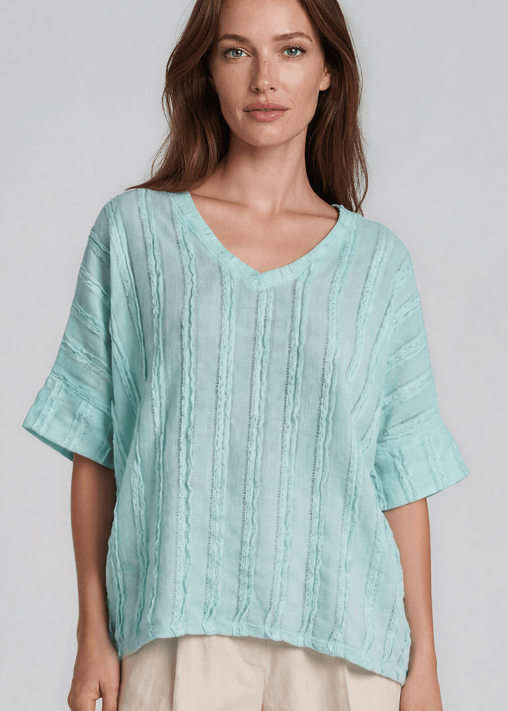 Shop the Laurel Textured Top in Aqua Blue — a relaxed oversized v-neck with striped lace effect, contrast sleeve bands &amp; side slit. Made in USA.