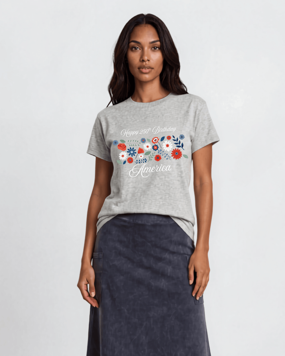 "Happy 250th Birthday America" floral graphic tee — red, white & blue wildflowers on heather gray. Made in USA, 100% cotton, relaxed fit, XS–3X. Perfect for 4th of July.