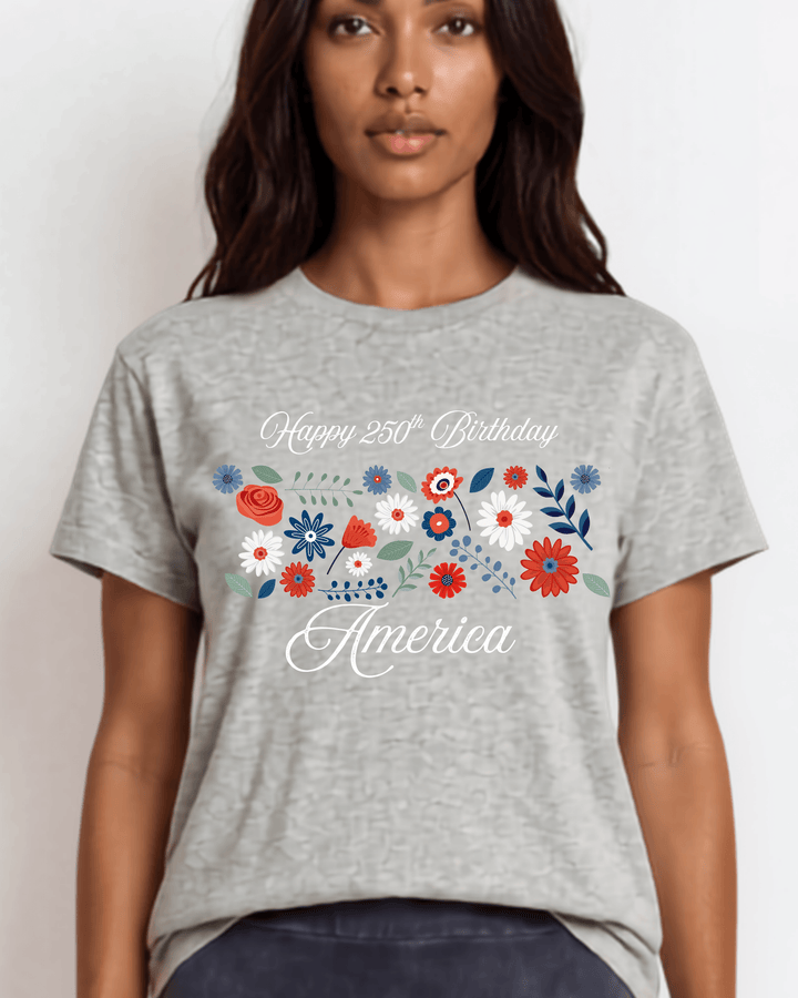 "Happy 250th Birthday America" floral graphic tee — red, white &amp; blue wildflowers on heather gray. Made in USA, 100% cotton, relaxed fit, XS–3X. Perfect for 4th of July.