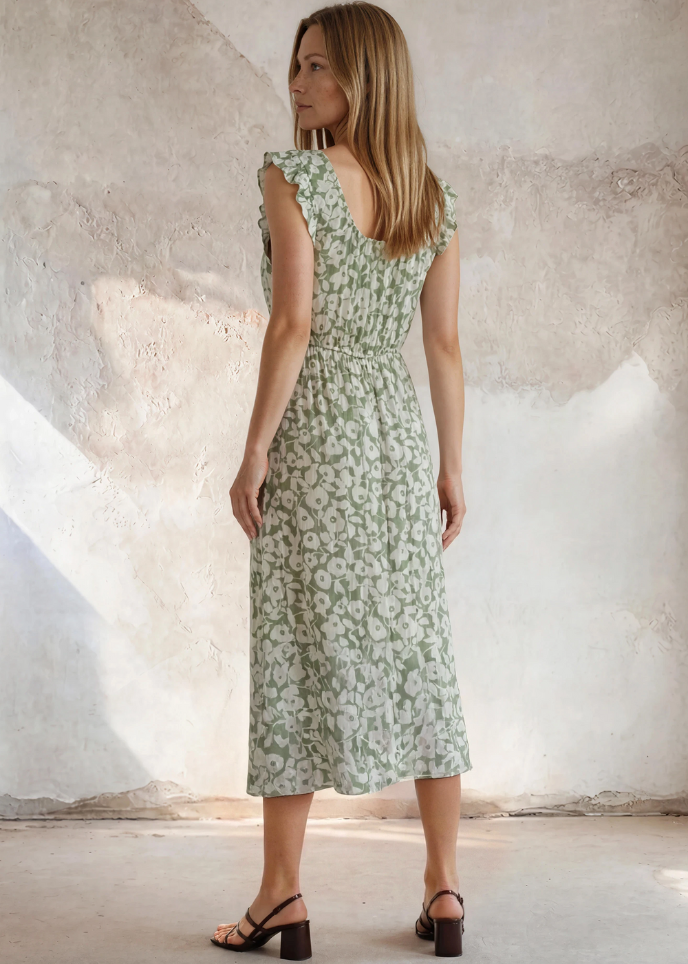 Lightweight sage green floral midi dress with a square neckline, tie front detail, ruffled cap sleeves, and smocked waist. Made in USA. Available in sizes S-XL.