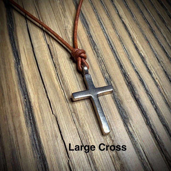 Handcrafted solid bronze cross on an adjustable leather cord. Unisex, red brown or dark brown. Made in USA with a lifetime warranty