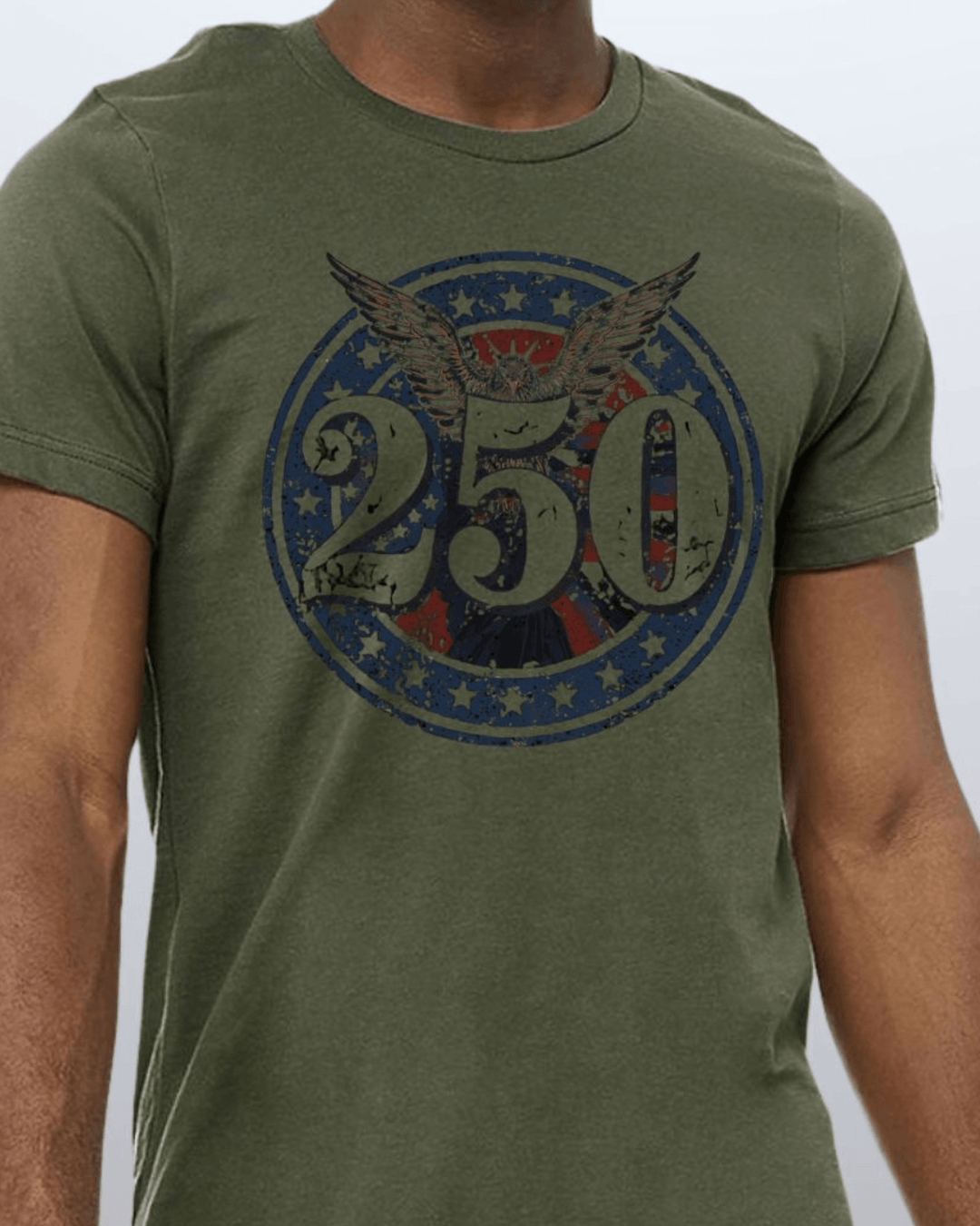 Shop the 250 Emblem Patriotic Tee — Made in USA. Bold bald eagle & American flag circle graphic on army green. Soft 100% cotton. Perfect for 4th of July. S-XL.