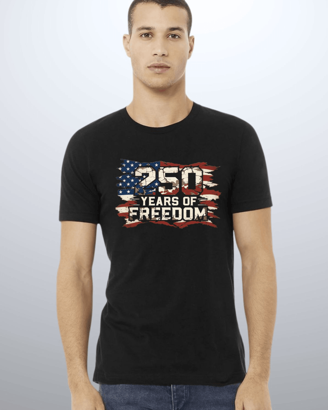 250 Years of Freedom Distressed Flag Tee — Made in USA. Bold cracked flag graphic on black, soft 100% cotton, relaxed fit. Perfect for 4th of July. Sizes S-XL.