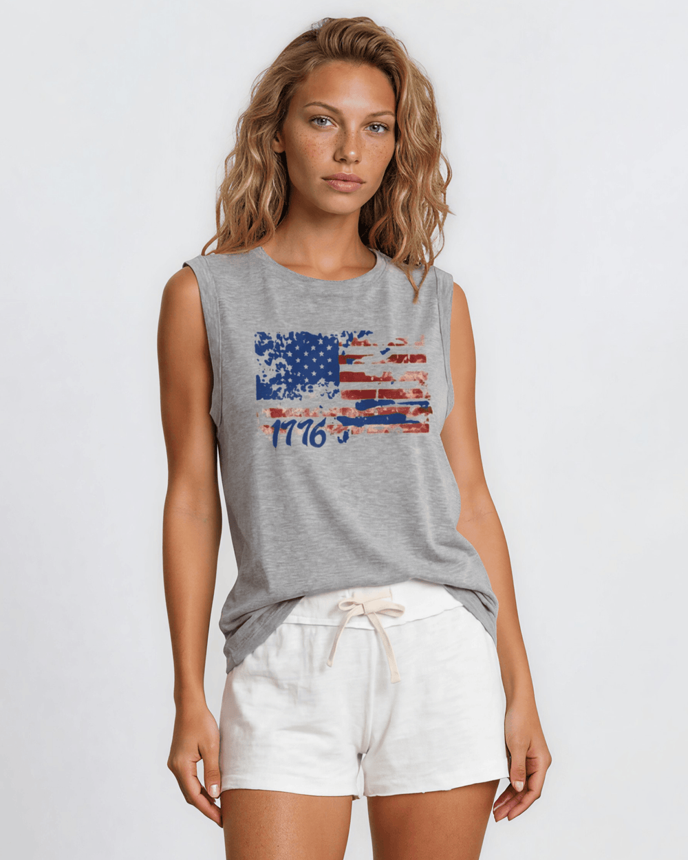 1776 Distressed American Flag Graphic Muscle Tee — Made in USA. Bold red, white & blue flag design, relaxed fit, 75% cotton. Perfect for 4th of July. Sizes S-L.