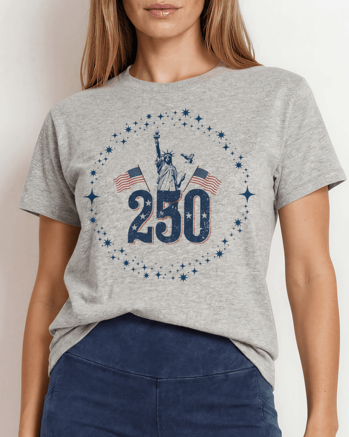 250 Statue of Liberty Patriotic Graphic Tee — Made in USA. Lady Liberty &amp; American flags on heather gray, 100% cotton, relaxed fit. Perfect for 4th of July.