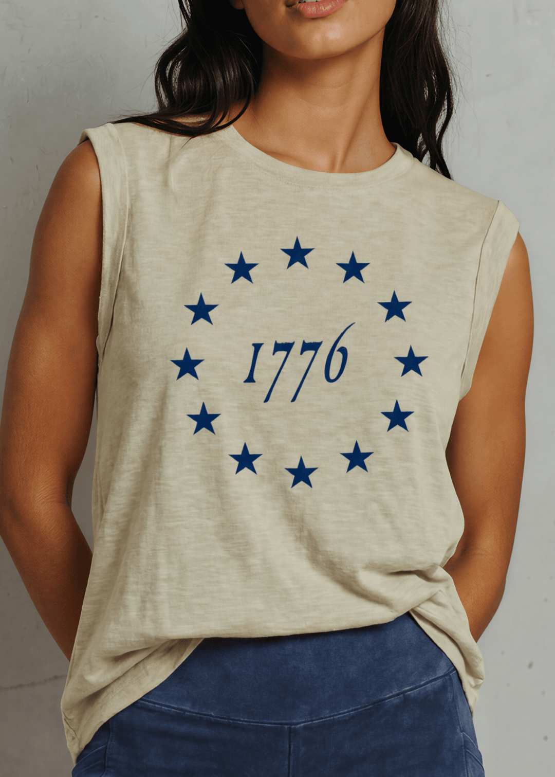 1776 Betsy Ross 13 Stars Graphic Muscle Tee — Made in USA. Light olive, relaxed fit, 75% cotton. Sleeveless patriotic top perfect for 4th of July. Sizes S-L.