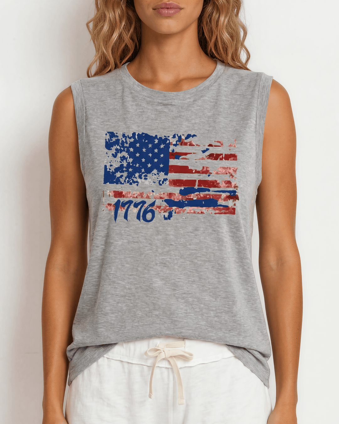 1776 Distressed American Flag Graphic Muscle Tee — Made in USA. Bold red, white & blue flag design, relaxed fit, 75% cotton. Perfect for 4th of July. Sizes S-L.