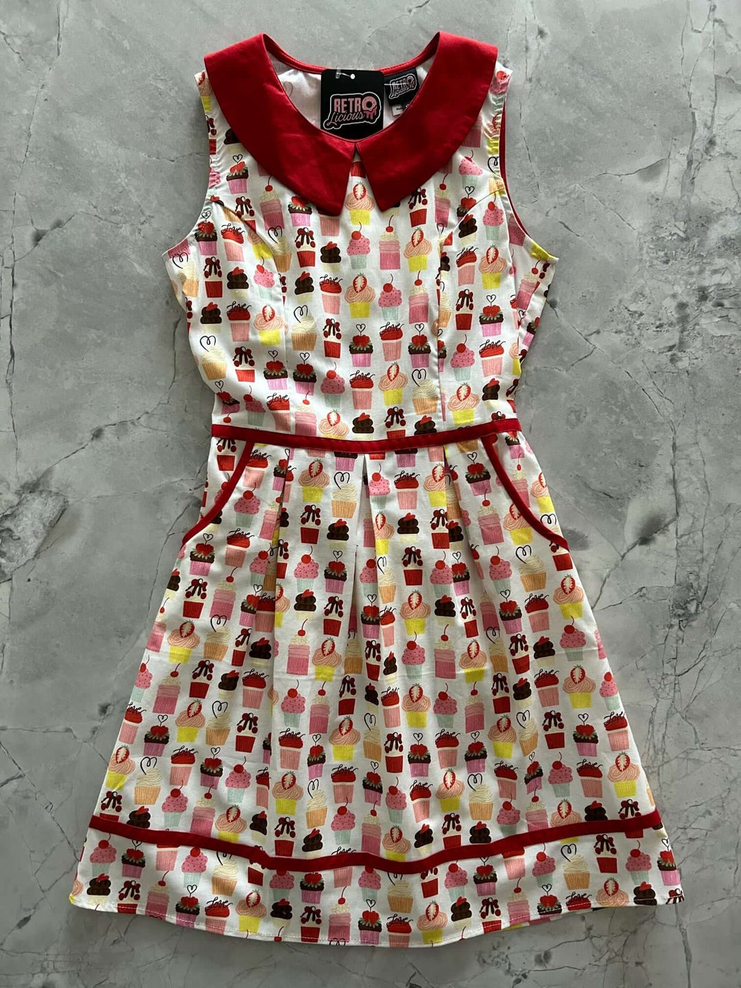 Made in USA. Shop the Retrolicious Cupcake Collared Dress in 100% cotton, with a Peter Pan collar, contrast piping, A-line skirt and pockets.