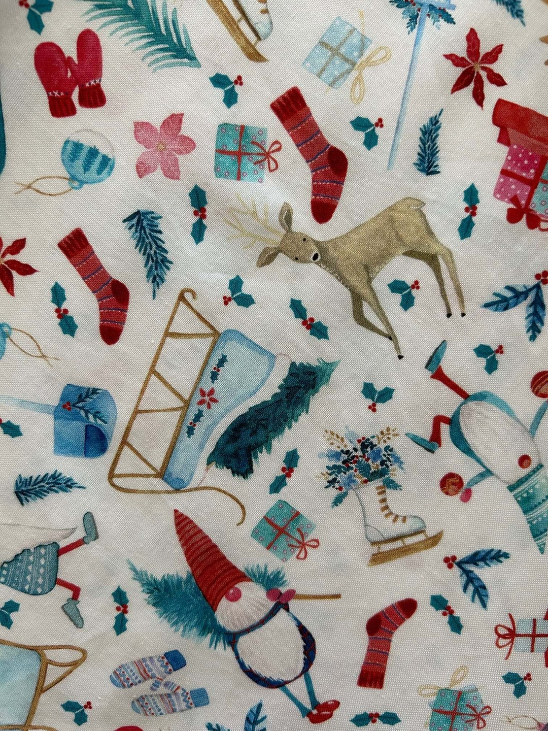 Introducing our Winter Cheer Vintage Dress. This dress boasts a fun and playful print featuring gnomes, sleds, ice skates, mittens, and reindeer. It&