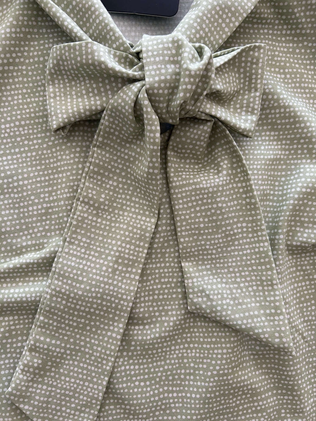 Vintage Style Tops This top is for the vintage lover at heart! Now available in our Sage Dot print. This 100% cotton top features bust darts for a flattering silhouette, a side zippered closure for ease of wear, and an oversized bow at the neckline for that perfect 1950&