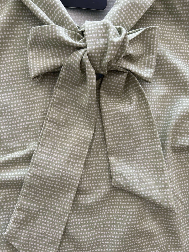 Vintage Style Tops This top is for the vintage lover at heart! Now available in our Sage Dot print. This 100% cotton top features bust darts for a flattering silhouette, a side zippered closure for ease of wear, and an oversized bow at the neckline for that perfect 1950&