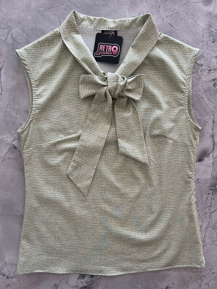 Vintage Style Tops This top is for the vintage lover at heart! Now available in our Sage Dot print. This 100% cotton top features bust darts for a flattering silhouette, a side zippered closure for ease of wear, and an oversized bow at the neckline for that perfect 1950&