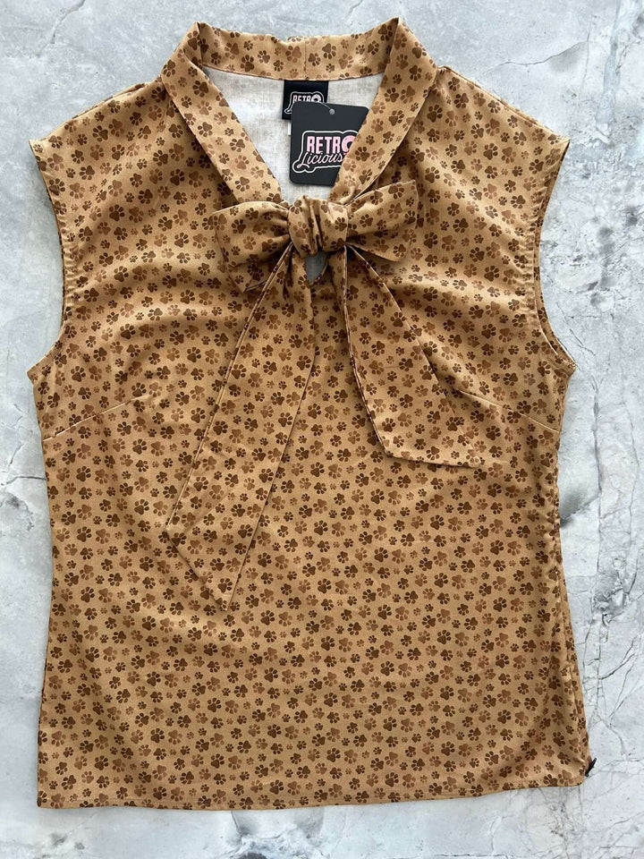 Vintage Style Tops This top is for the vintage lover at heart! Now available in our Paw print. This 100% cotton top features bust darts for a flattering silhouette, a side zippered closure for ease of wear, and an oversized bow at the neckline for that perfect 1950&