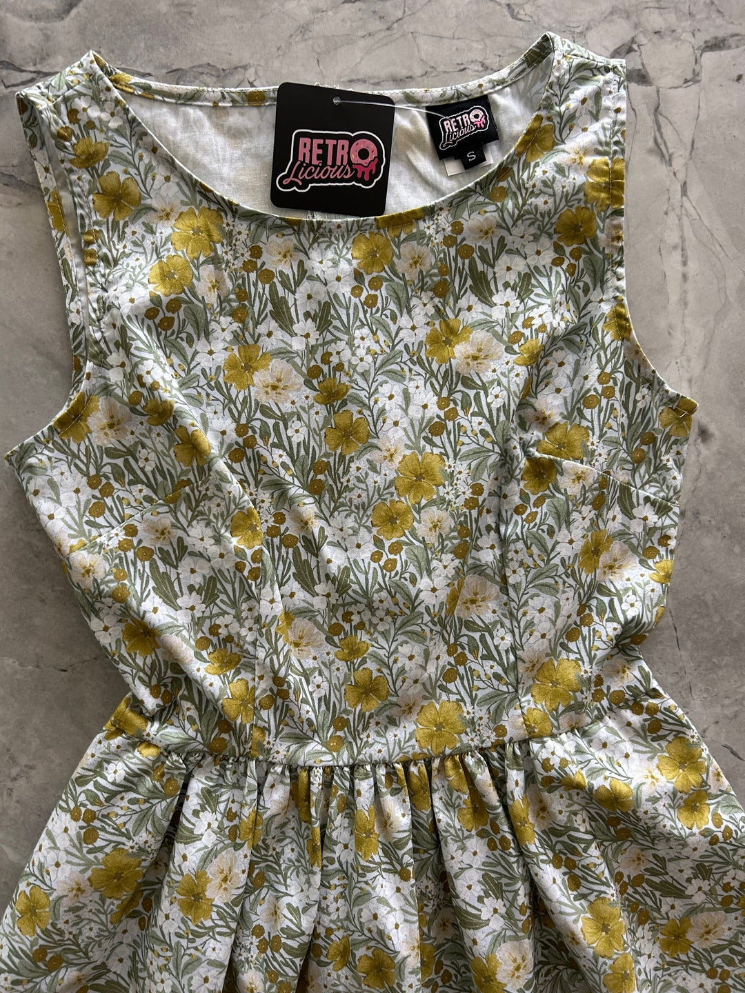 Made in USA. Shop the Mustard Floral cotton midi dress by Retrolicious, with a high neckline, full swing skirt and hidden pockets. Sizes XS–4X.