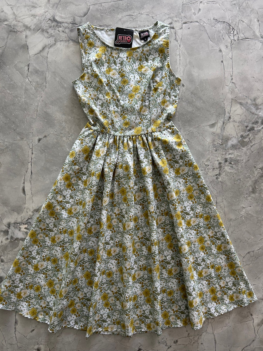 Made in USA. Shop the Mustard Floral cotton midi dress by Retrolicious, with a high neckline, full swing skirt and hidden pockets. Sizes XS–4X.