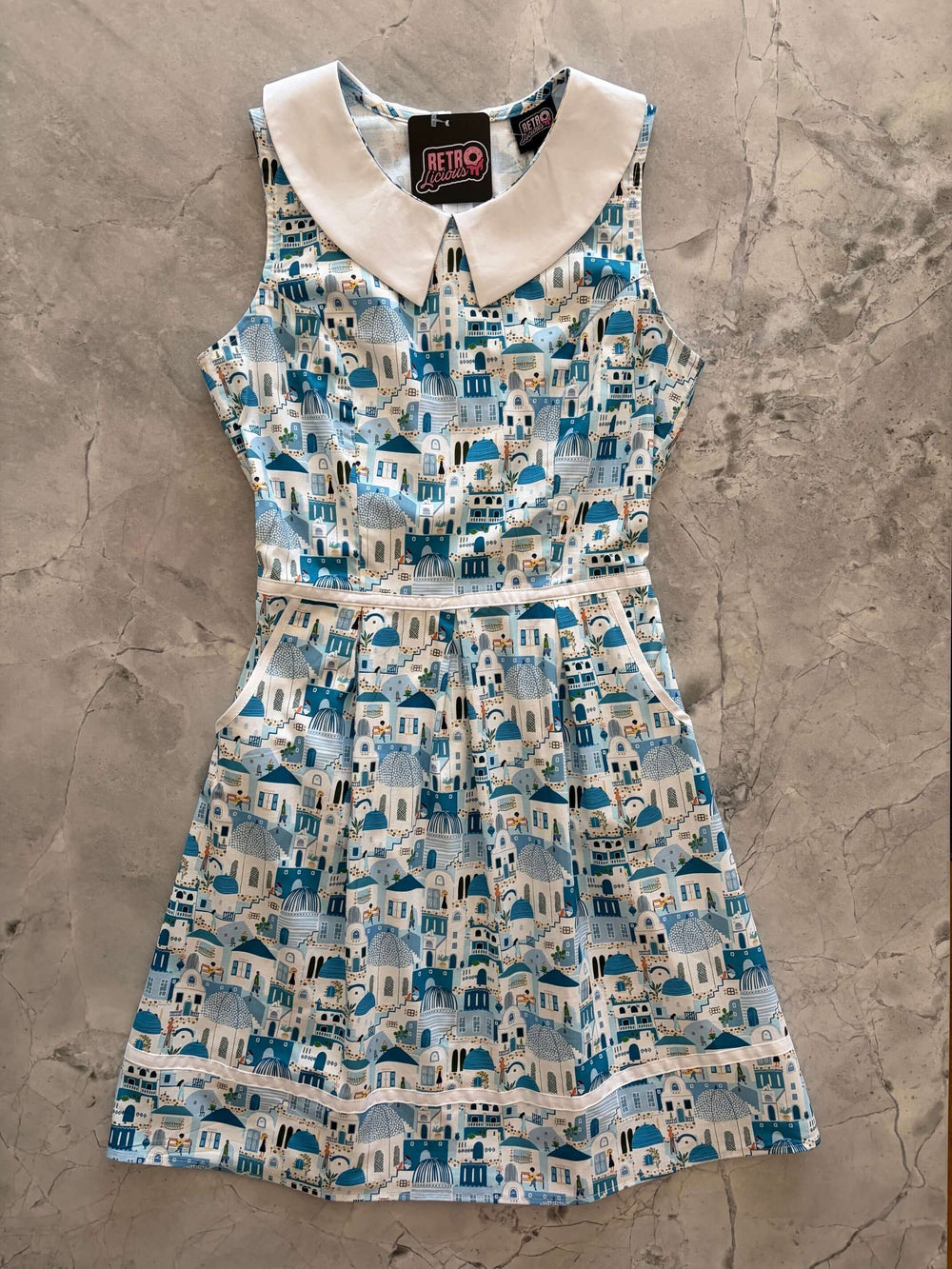Santorini Collared Dress by Retrolicious — 60s-style A-line, Santorini print, Peter Pan collar, pockets, 100% cotton. Made in USA. Sizes XS–4X.