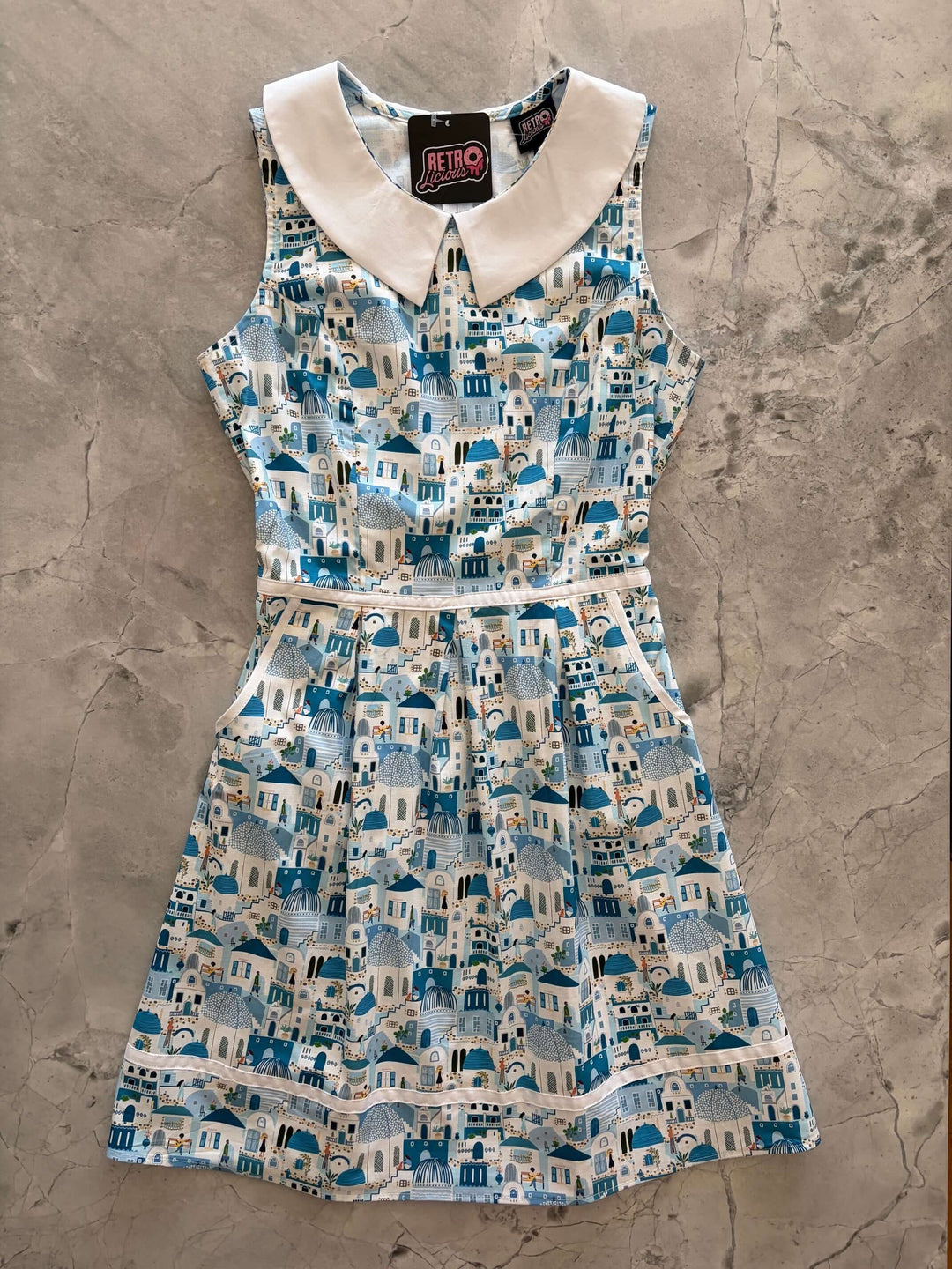 Santorini Collared Dress by Retrolicious — 60s-style A-line, Santorini print, Peter Pan collar, pockets, 100% cotton. Made in USA. Sizes XS–4X.