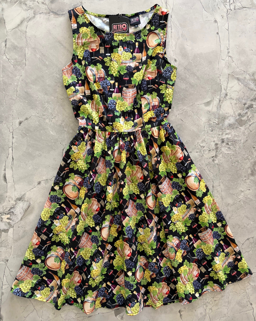 Made in USA. Shop the Wine Vintage Dress by Retrolicious in 100% cotton, with a high neckline, longer full skirt and hidden pockets. Sizes XS–4X.