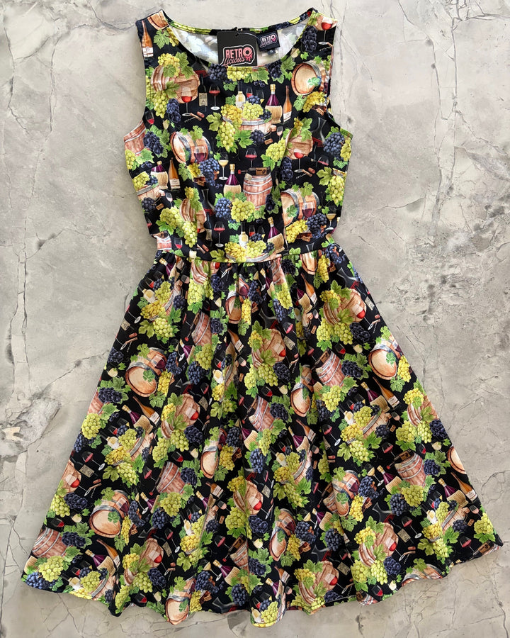 Made in USA. Shop the Wine Vintage Dress by Retrolicious in 100% cotton, with a high neckline, longer full skirt and hidden pockets. Sizes XS–4X.