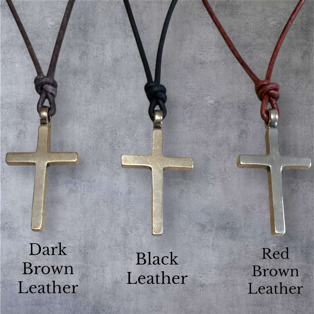 Handcrafted solid bronze cross on an adjustable leather cord. Unisex, red brown or dark brown. Made in USA with a lifetime warranty