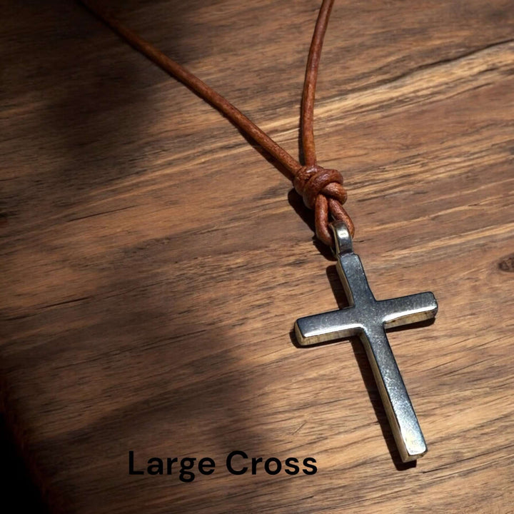 Handcrafted solid bronze cross on an adjustable leather cord. Unisex, red brown or dark brown. Made in USA with a lifetime warranty