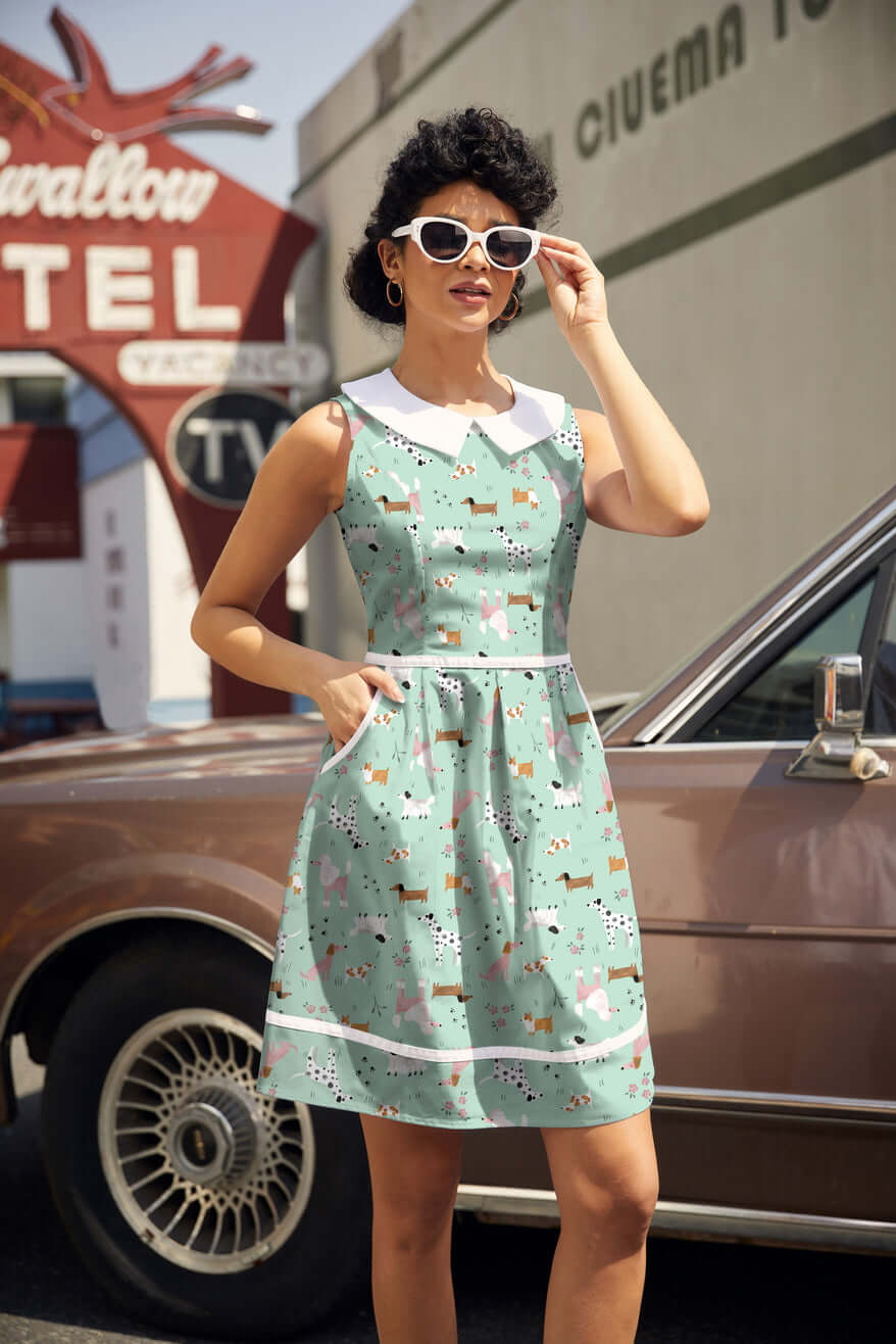 Shop the Dogs Collared Dress by Retrolicious — 60s-style A-line, dog print, Peter Pan collar, pockets, 100% cotton. Made in USA. Sizes XS–4X.