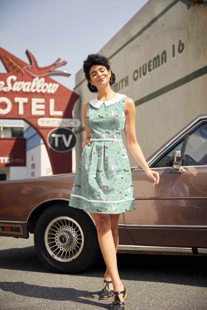 Shop the Dogs Collared Dress by Retrolicious — 60s-style A-line, dog print, Peter Pan collar, pockets, 100% cotton. Made in USA. Sizes XS–4X.