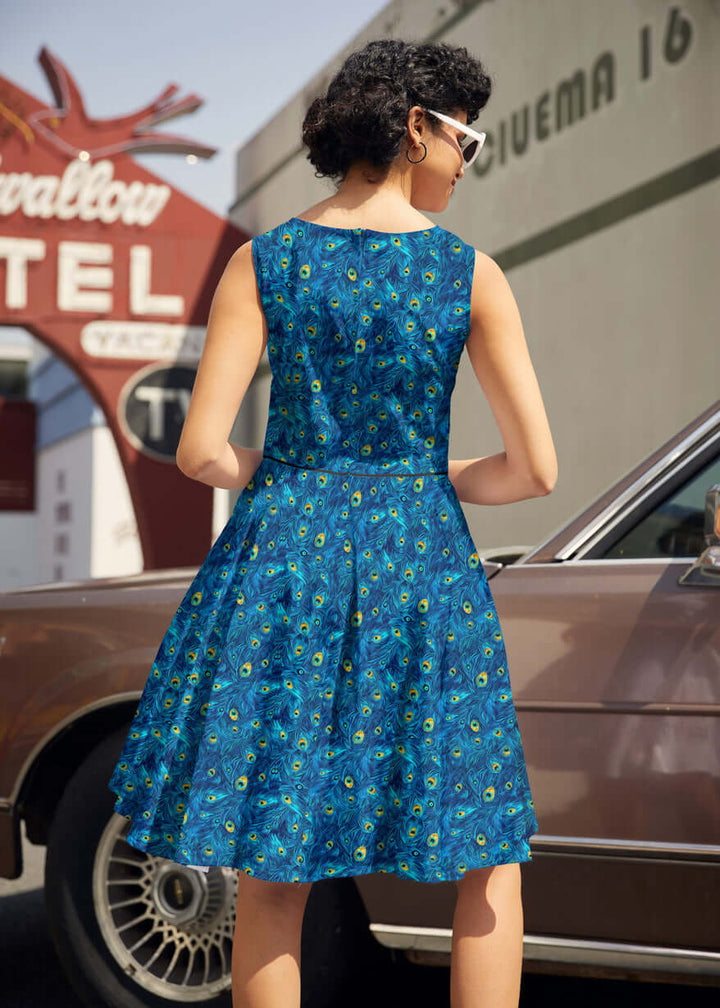 Shop the Elizabeth Dress by Retrolicious — vintage peacock print, piping details, knee length, pockets, 100% cotton. Made in USA. Sizes XS–4X.