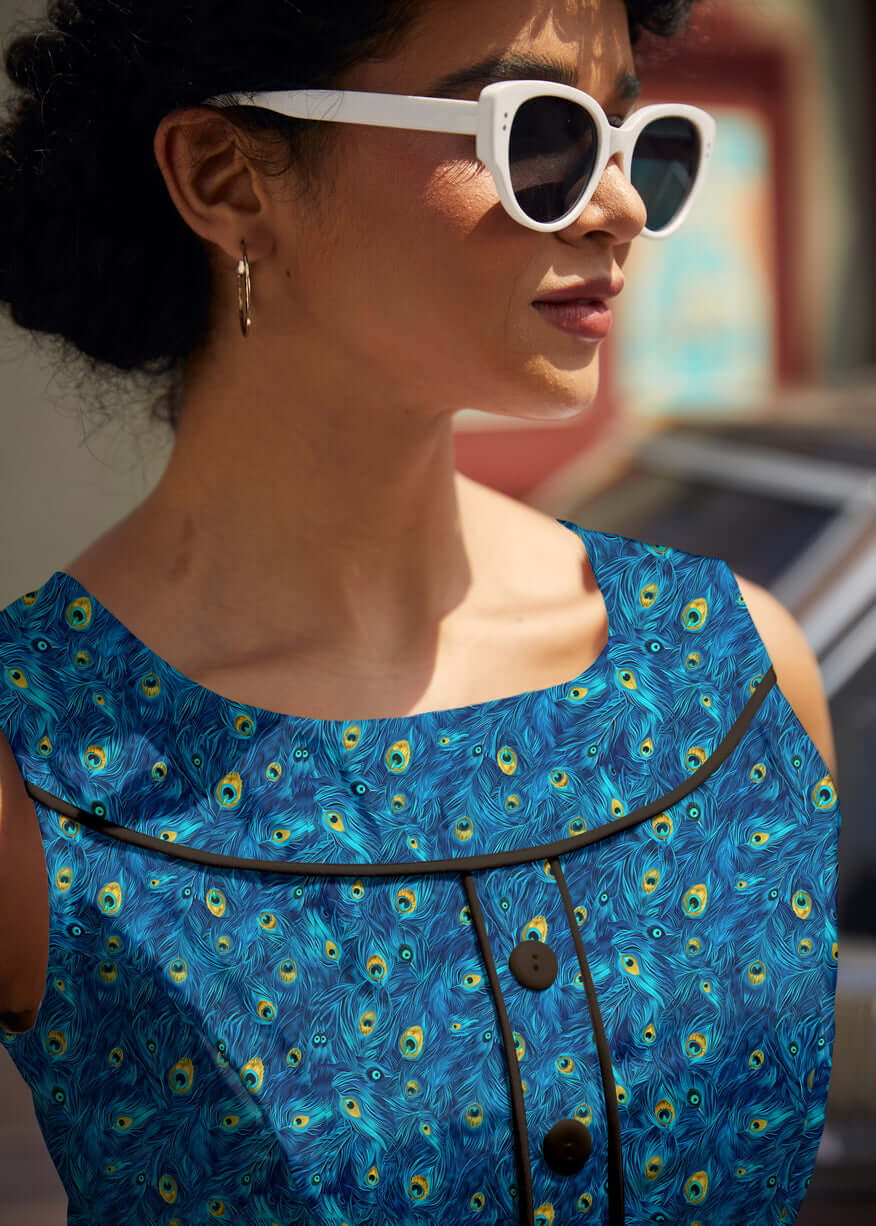 Shop the Elizabeth Dress by Retrolicious — vintage peacock print, piping details, knee length, pockets, 100% cotton. Made in USA. Sizes XS–4X.